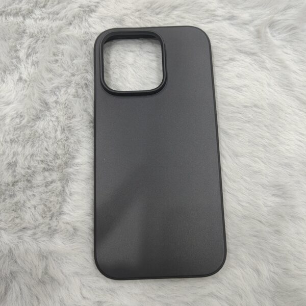 matte black protective smartphone cases resting on a soft, plush white faux-fur surface