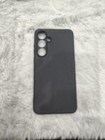 matte black protective smartphone cases resting on a soft, plush white faux-fur surface - Image 3