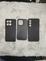 matte black protective smartphone cases resting on a soft, plush white faux-fur surface - Image 4